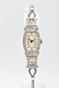 AN EARLY 20TH CENTURY DIAMOND COCKTAIL WATCH, tonneau shape case diamond set with single cut