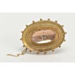 A LATE VICTORIAN BROOCH, of an oval form set with a single rose cut diamond, within a floral