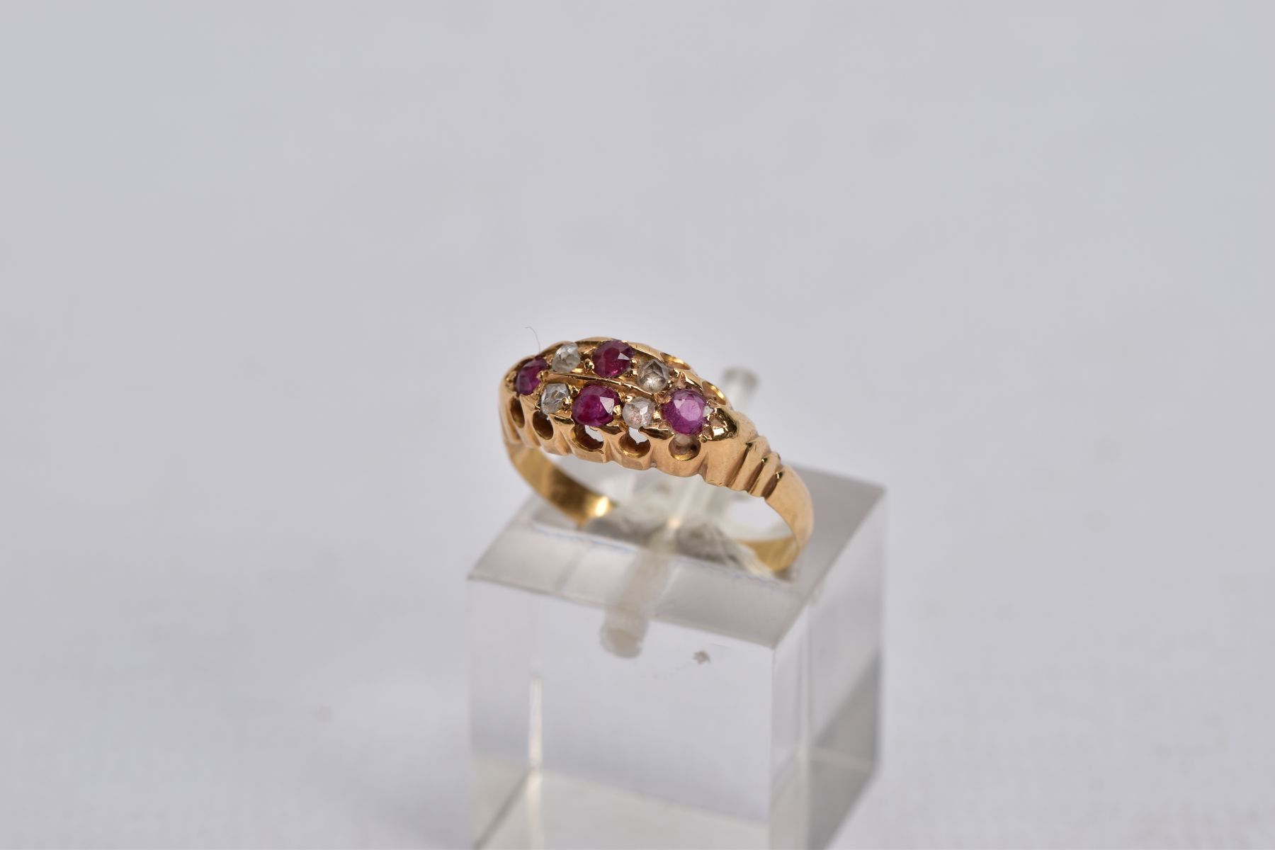 A VICTORIAN DIAMOND AND RUBY BOAT RING, set with four circular cut rubies, interspaced with four