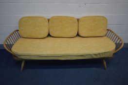 AN ERCOL BLONDE ELM AND BEECH STUDIO COUCH, MODEL 355, with later fire regulated cushions, length