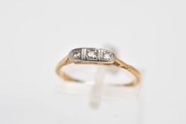 A YELLOW METAL THREE STONE DIAMOND RING, designed with three graduated single cut diamonds, total