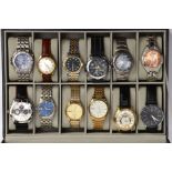 A WATCH DISPLAY CASE WITH WATCHES, faux leather black case with a glass window, twelve watch storage