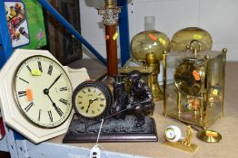A GROUP OF FIVE QUARTZ CLOCKS WITH ONE OIL LAMP, including two novelty golfing interest clocks, (