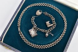 A BOXED SILVER CHAIN AND A SILVER CHARM BRACELET, the chain of an articulated flat bead design,