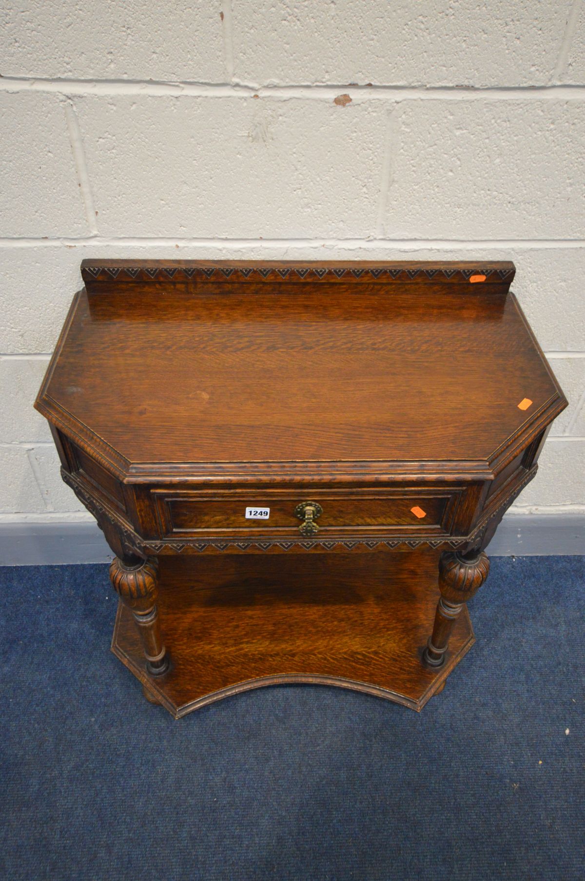 AN OAK SIDE TABLE with a raised back, canted front corners and a single frieze drawer, on acorn - Image 2 of 3