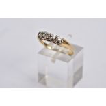 A YELLOW METAL DIAMOND RING, designed with a row of five claw set, round brilliant cut diamonds,