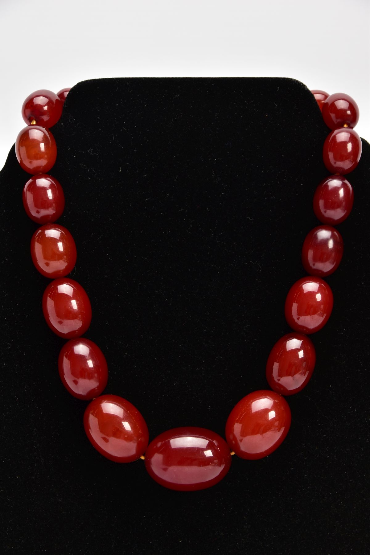 A CHERRY AMBER GRADUATED BEAD NECKLACE, the largest measuring approximately 31.7mm x 23.3mm, the - Image 4 of 4