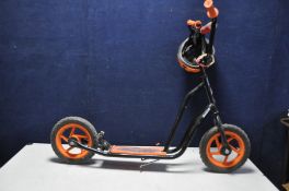 A SKOOTER CHILDS SCOOTER, 115cm long with a cycle helmet