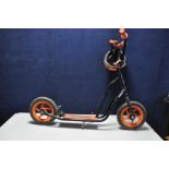 A SKOOTER CHILDS SCOOTER, 115cm long with a cycle helmet