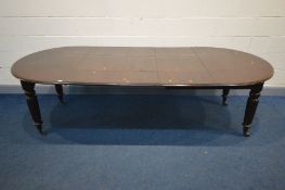 A VICTORIAN MAHOGANY PULL OUT DINING TABLE, with rounded ends, three additional leaves, on fluted