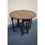 A SMALL GEORGIAN OVAL OAK GATE LEG TABLE, single frieze drawer, on turned and block legs, and shaped