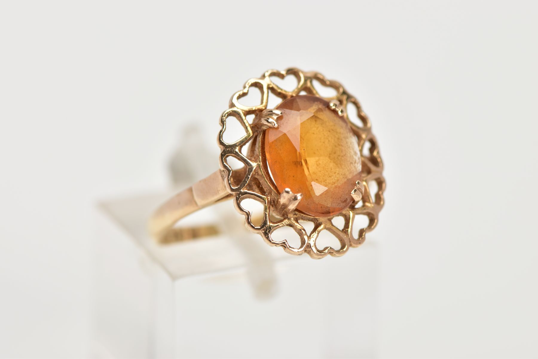 A YELLOW METAL CITRINE RING, designed with a claw set oval cut citrine, within an openwork heart - Image 4 of 4