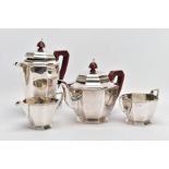A GEORGE VI SILVER FOUR-PIECE TEA SET, to include a teapot and hot water jug, each with a wooden