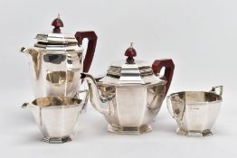 A GEORGE VI SILVER FOUR-PIECE TEA SET, to include a teapot and hot water jug, each with a wooden