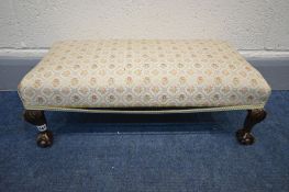 A MAHOGANY FOOTSTOOL on ball and claw feet, length 64cm (trim loose)