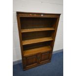 AN OLD CHARM OPEN BOOKCASE, two adjustable shelves above a double door cupboard, width 92cm x