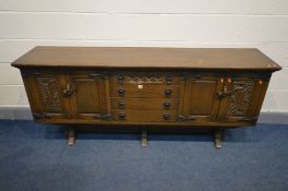 AN OAK OLD CHARM STYLE OAK SIDEBOARD, with double cupboard doors flanking four drawers, width