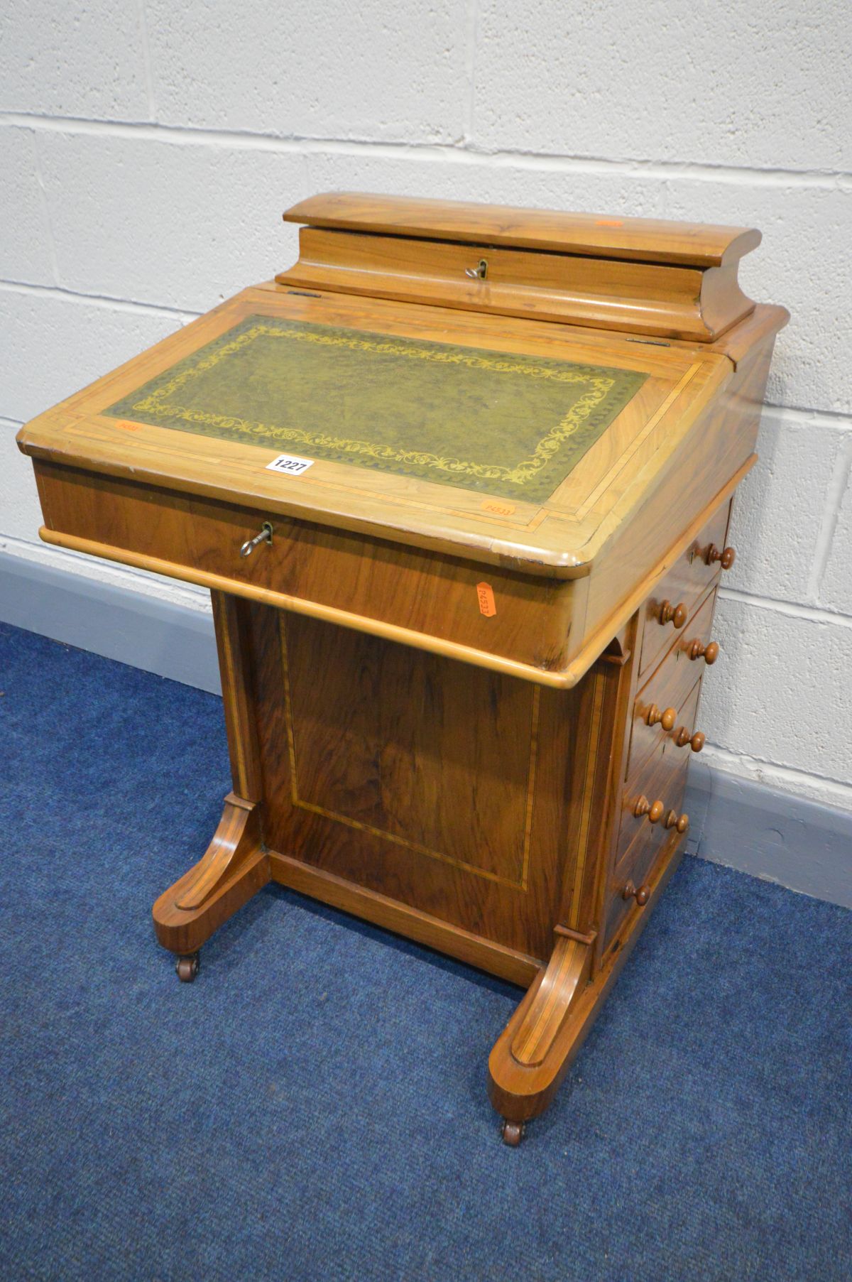 A 19TH CENTURY WALNUT AND INLAID DAVENPORT, a stationery compartment above a lid enclosing four