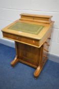 A 19TH CENTURY WALNUT AND INLAID DAVENPORT, a stationery compartment above a lid enclosing four