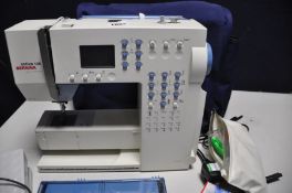 A BERNINA ACTIVA 135 SEWING MACHINE with power cable, footswitch, cover, box of accessories etc