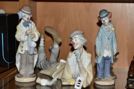 THREE LLADRO CLOWN FIGURES, comprising 4618 clown lying down with a ball at his feet, designed by