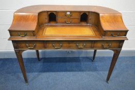 A REPRODUCTION MAHOGANY CARLTON HOUSE STYLE DESK, in the George III style, with an arrangement of