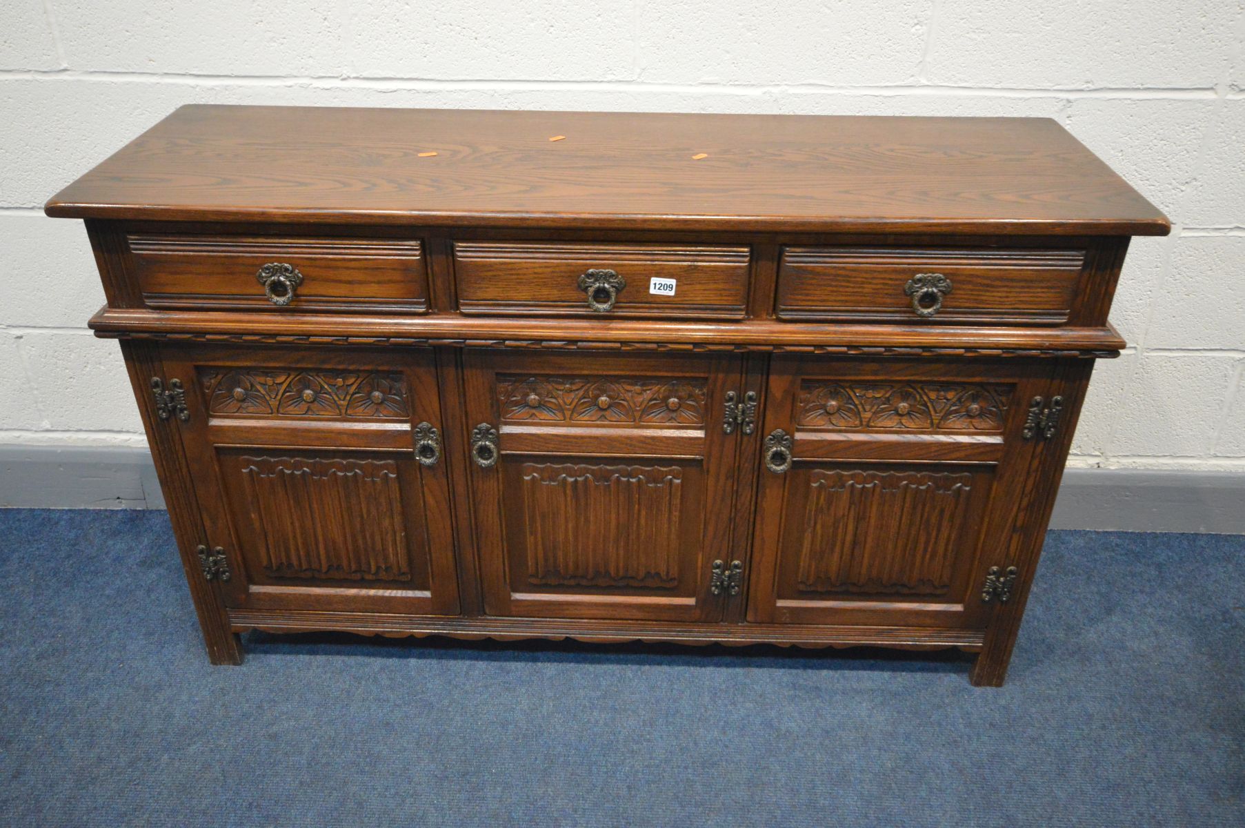 AN OLD CHARM SIDEBOARD, three drawers above three cupboard doors, width 136cm x depth 44cm x