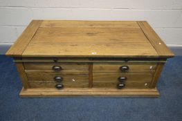 A HEAVY SOLID OAK COFFEE TABLE, with an assortment of drawers, and two brushing slides, length 131cm
