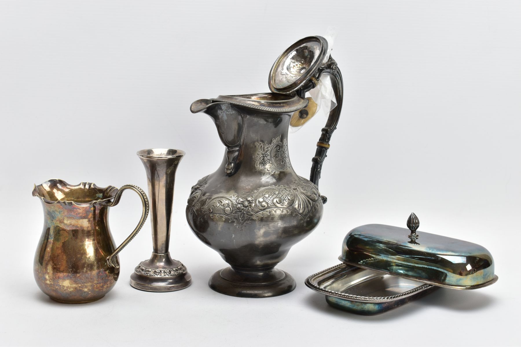 A SELECTION OF ITEMS, to include an AF, white metal floral and foliate embossed water jug, (