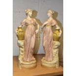 A PAIR OF ROYAL DUX FIGURES OF FEMALE WATER CARRIERS IN CLASSICAL DRESS, impressed numbers 2063
