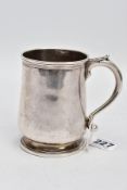 A GEORGE II HALF PINT SILVER TANKARD, plain polished bell shape design, textured leaf thumb rest