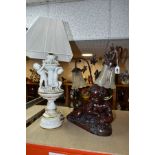 A BRONZED RESIN TABLE LAMP IN THE FORM OF A CHERUB, signed Itassi, twin shades with leaf decoration,