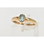 A 9CT GOLD TOPAZ RING, designed as an oval blue topaz within a collet setting, to the plain band,