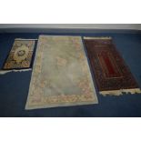 A WOOLLEN RED GROUND RUG, 160cm x 92cm, along with two Chinese rugs, largest rug size 189cm x