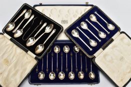 THREE CASED SETS OF SILVER SPOONS, to include a twelve-piece coffee spoon set, each with a wooden