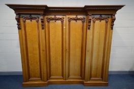 A VICTORIAN OAK INVERTED BREAKFRONT COMPACTUM WARDROBE, overhanging cornice, heavily carved