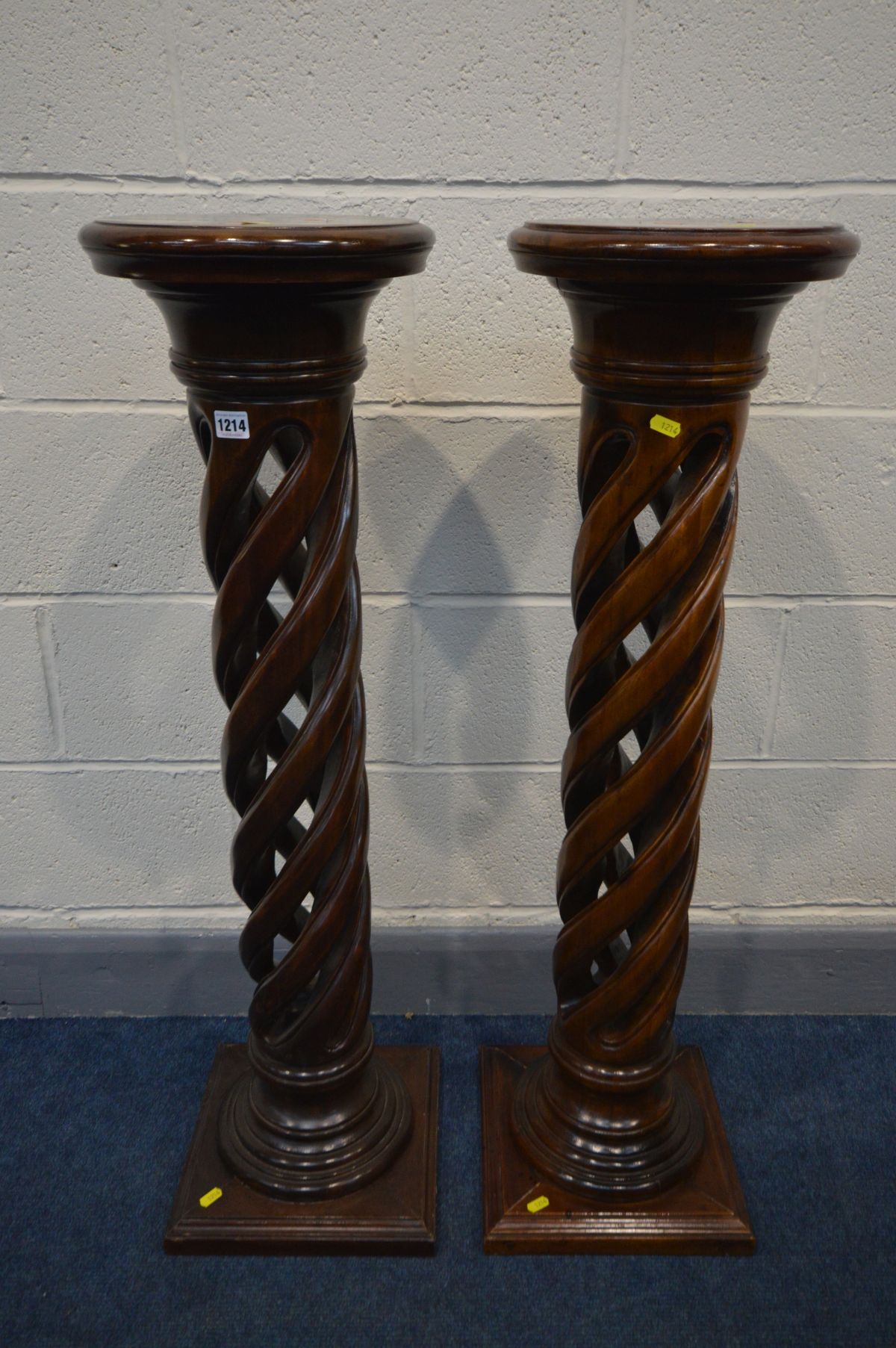 A PAIR OF MODERN MAHOGANY TORCHERE STANDS, circular tops on an open barley twist support and