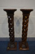 A PAIR OF MODERN MAHOGANY TORCHERE STANDS, circular tops on an open barley twist support and