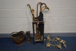 AN EARLY 20TH CENTURY OAK UMBRELLA STAND containing umbrellas together with a brass and copper