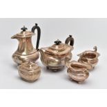A SILVER FIVE-PIECE TEA SET, to include a teapot and hot water jug each with a wooden scroll