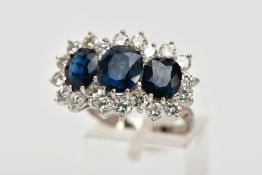 A LARGE SAPPHIRE AND DIAMOND TRIPLE CLUSTER RING. Largest blue sapphire measuring approximately 8.