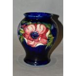 A MOORCROFT POTTERY ANEMONE PATTERN BALUSTER VASE, on a blue ground, painted WM initials,