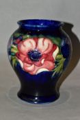 A MOORCROFT POTTERY ANEMONE PATTERN BALUSTER VASE, on a blue ground, painted WM initials,