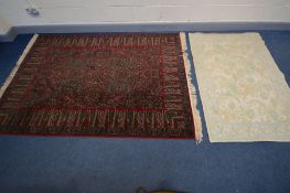 A WOOLLEN CARPET SQUARE, of an unusual design, red field and green pattern, 240cm x 170cm, label