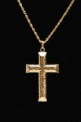 A YELLOW METAL CROSS PENDANT NECKLACE, textured hollow cross pendant, fitted with an oval suspension