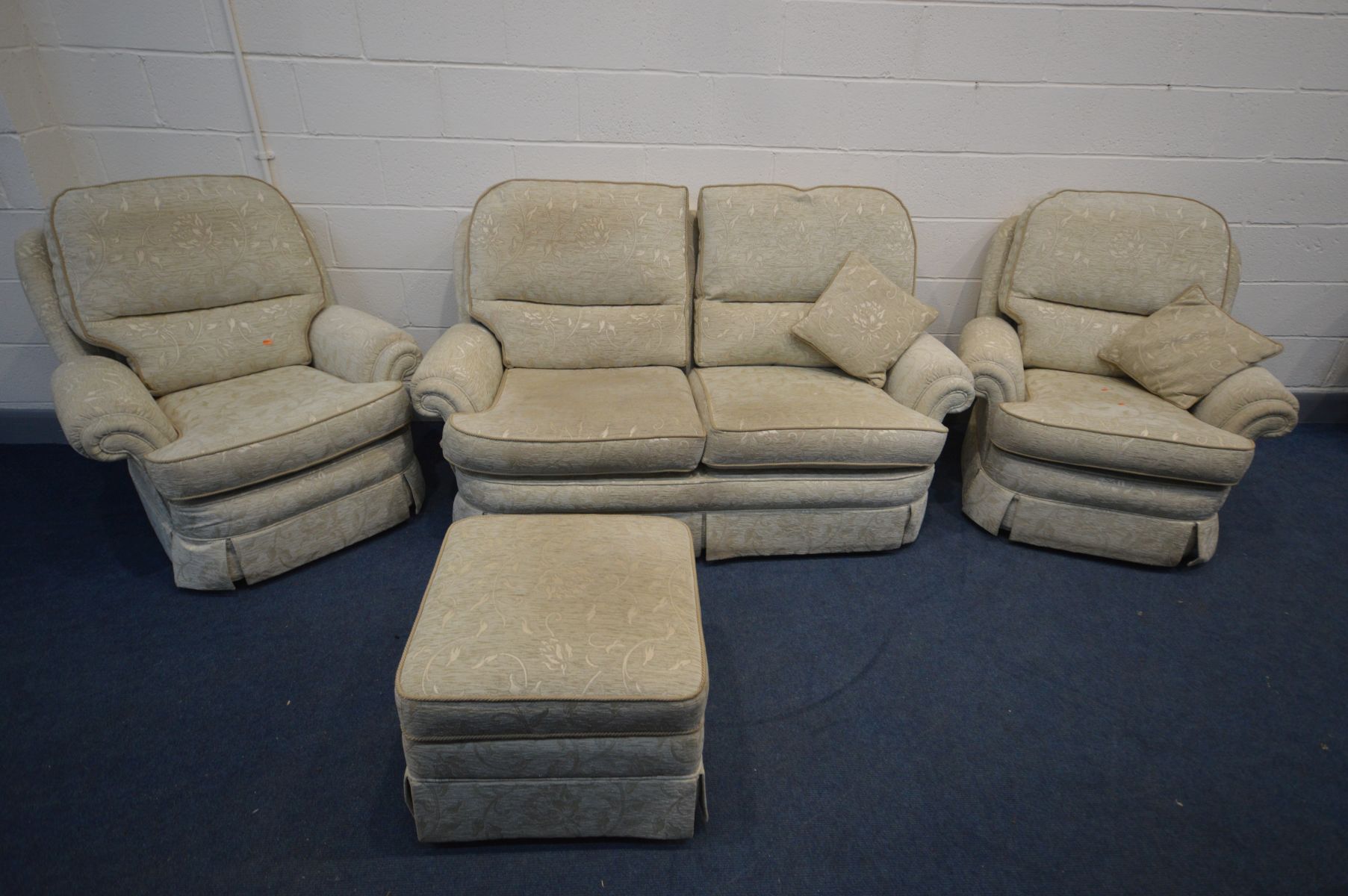 AN UPHOLSTERED THREE PIECE LOUNGE SUITE, comprising a two seater settee, pair of armchairs and a