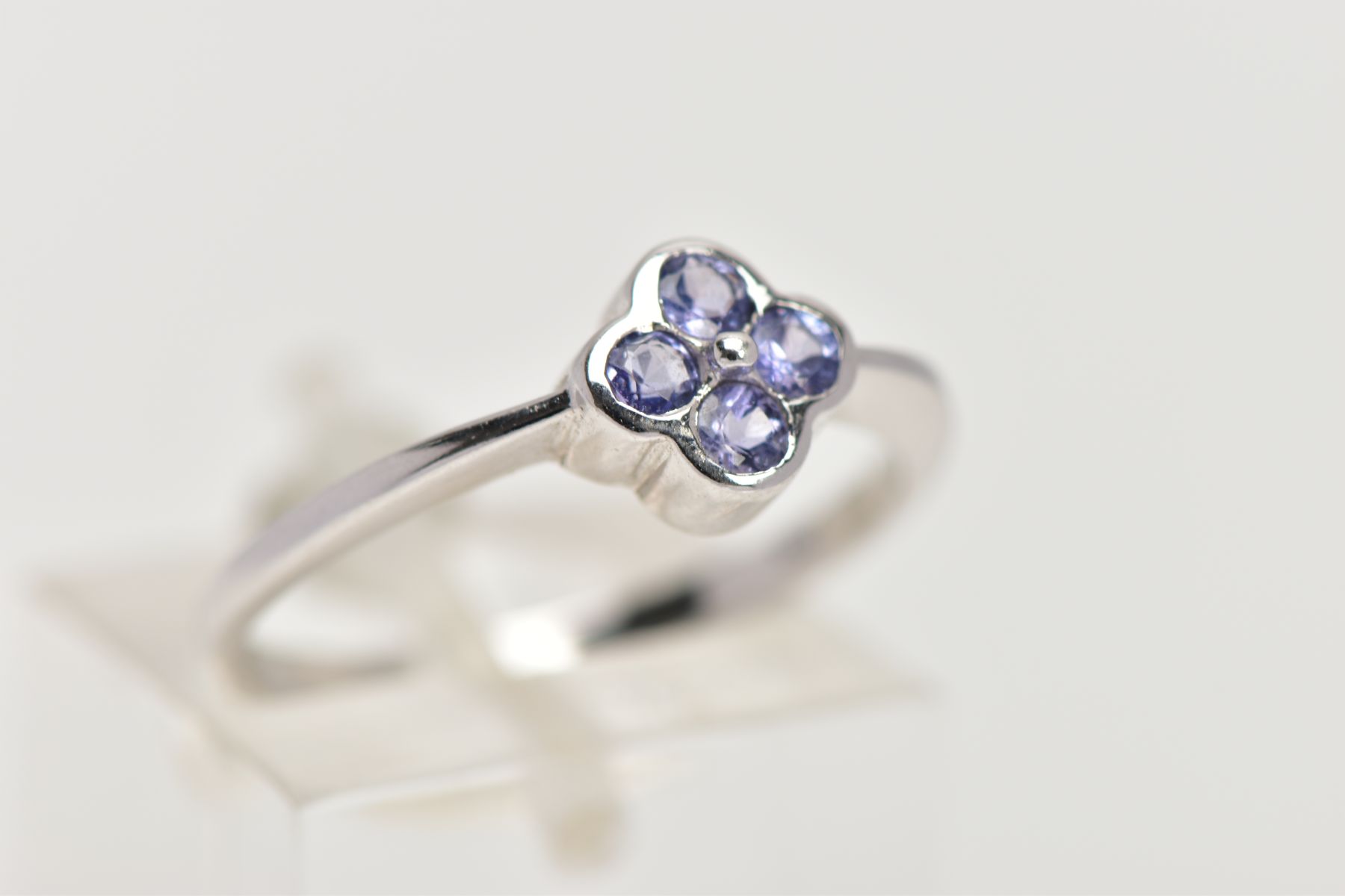 A 9CT WHITE GOLD TANZANITE DRESS RING, designed as four circular cut tanzanites within a - Image 4 of 4