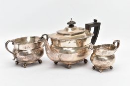 AN EARLY 20TH CENTURY THREE PIECE SILVER TEA SET, to a plain polished teapot, engraved monogram to