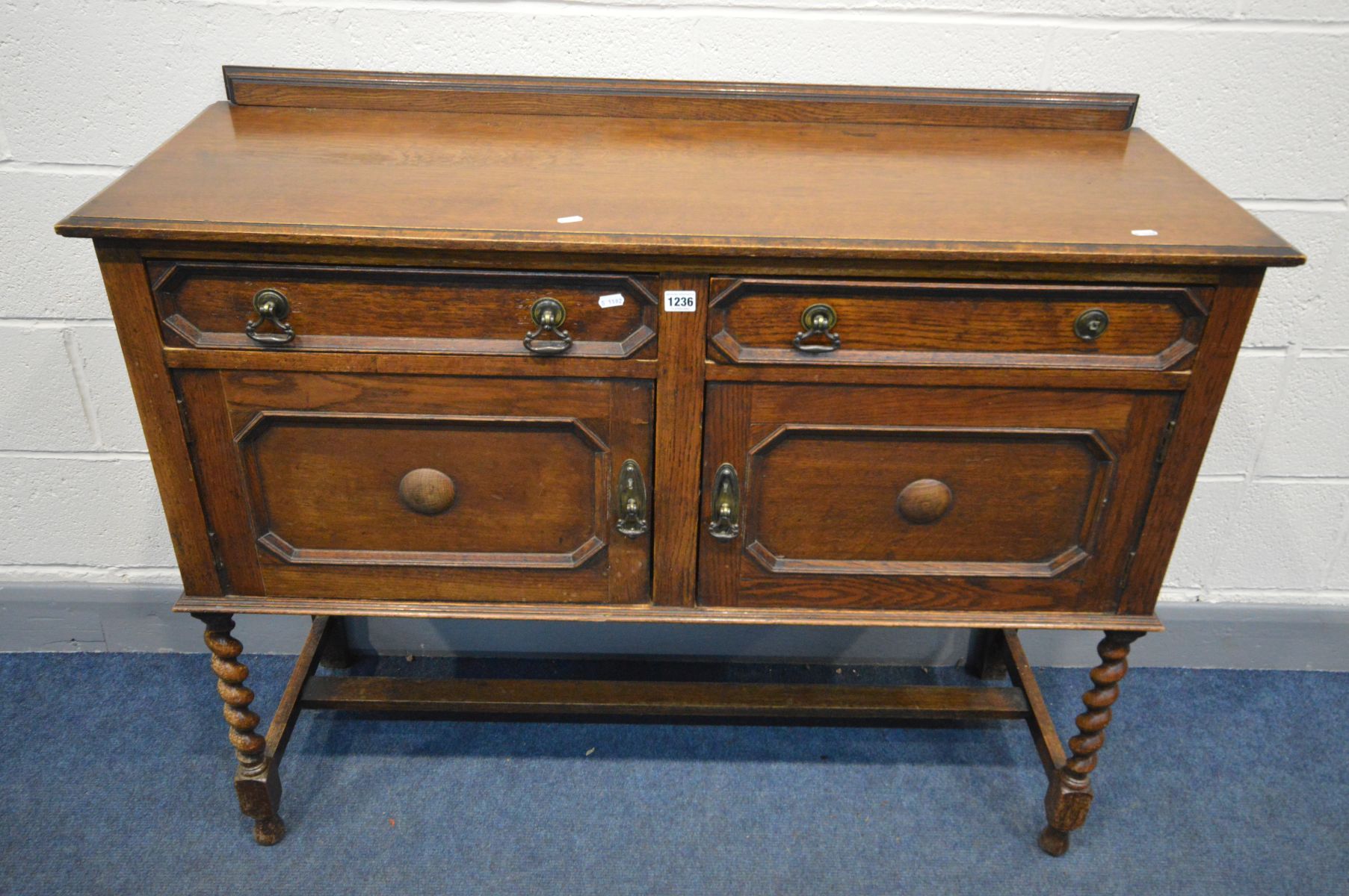 AN EARLY 20TH CENTURY OAK SIDEBOARD, two drawers above two cupboard doors, barley twist front
