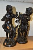 A PAIR OF VICTORIAN STYLE BRONZES OF A SMALL BOY AND GIRL, the girl with a small bird perched on her